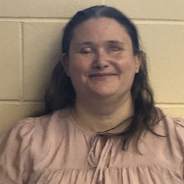 Jamie Richey wearing a white shirt, smiling at the camera.