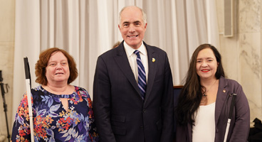 Lynn and Emily pose for a photo with Senator Bob Casey.